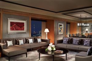 a living room with couches and a table at The Ritz-Carlton, Tokyo in Tokyo