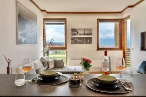 a living room with a table with glasses of wine at Peaceful Condo w/ Amazing View in Bansko