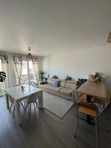 uma sala de estar com uma mesa e um sofá em Appartement Nanterre em Nanterre