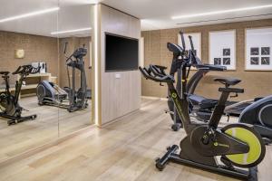 a gym with exercise bikes and a flat screen tv at AC Hotel by Marriott Tenerife in Santa Cruz de Tenerife