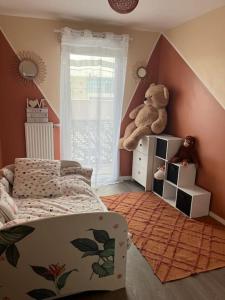 a bedroom with a bed and a teddy bear on a shelf at Appartement Nanterre in Nanterre