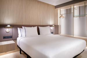a large white bed in a hotel room at AC Hotel by Marriott Tenerife in Santa Cruz de Tenerife