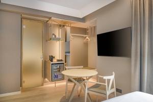 a small kitchen and dining room with a table and chairs at AC Hotel by Marriott Tenerife in Santa Cruz de Tenerife