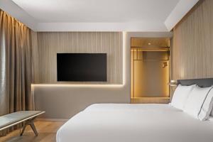 a hotel room with a bed and a television at AC Hotel by Marriott Tenerife in Santa Cruz de Tenerife