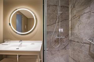 a bathroom with a sink and a shower with a mirror at AC Hotel by Marriott Tenerife in Santa Cruz de Tenerife