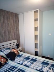 - une chambre avec un lit et une couette bleue et blanche dans l'établissement Au Bercail, à Gérardmer