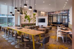 a conference room with tables and chairs and a screen at Residence Inn Washington Capitol Hill/Navy Yard in Washington