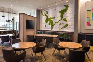 a restaurant with tables and chairs and a map on the wall at Residence Inn Washington Capitol Hill/Navy Yard in Washington
