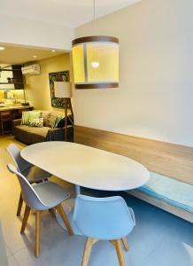 a dining room with a white table and chairs at Porto Smeralda Guarajuba C001 in Guarajuba