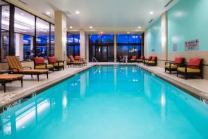 a pool in a hotel with chairs and tables at Denver Marriott Westminster in Westminster
