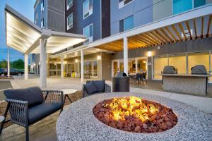 a patio with a fire pit in the middle of a building at TownePlace Suites by Marriott Asheville West in Asheville