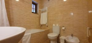 un bagno con vasca, WC e lavandino di Bungalows - Serra do Gerês a Campo do Gerês Altre 37 foto