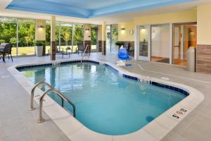 a swimming pool in a hotel room with a large pool at Fairfield Inn & Suites by Marriott St. Joseph in Saint Joseph