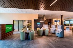 a lobby with couches and tables and chairs at Courtyard by Marriott Tampa Northwest/Veterans Expressway in Tampa