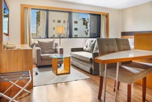 a living room with a couch and a table at Hotel Corporativo na Faria Lima in Sao Paulo +24 photos