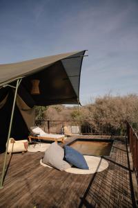 a large tent on a deck with a pool at Viatura Omún, San Miguel de Allende, All Inclusive in La Venta