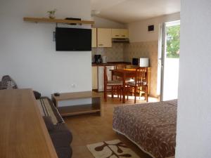 a room with a bed and a kitchen with a table at Studios Ivana in Umag