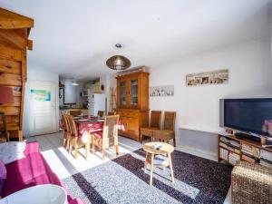 a living room with a table and a dining room at Appartement 8 personnes à Génos - Wifi, près du lac - FR-1-695-22 in Génos
