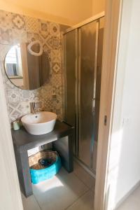 a bathroom with a sink and a shower at La Zagara in Aci Castello +24 photos