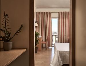 a hotel room with a bed and a balcony at Strada Marina Hotel in Zakynthos