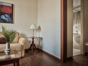 a living room with a chair and a table at Strada Marina Hotel in Zakynthos