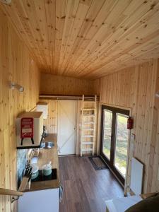 a kitchen with wooden walls and a wooden ceiling at Boerderij De Boshoeve in Sellingen