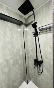 a shower in a bathroom with a shower head at Yas 2 Apartment in Samarkand