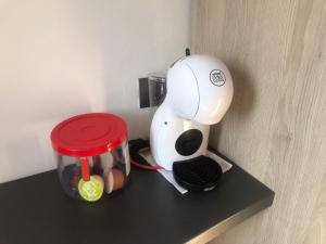 a coffee maker sitting on top of a black shelf at ApartamentoValleTena9 in Sabiñánigo