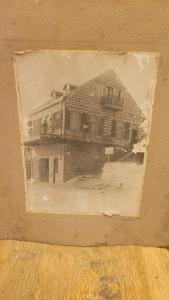an old picture of a house in a picture frame at מלון טיבריא in Tiberias