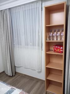a bedroom with a book shelf with bottles of water at Agréable Appartement parking - quai de la seine in Paris