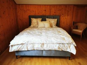 a bed in a room with a wooden wall at Marmottin in Luzern