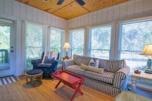 a living room with a couch and two chairs at Surfscoter in Johns Island