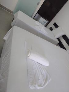 a close up of a white bed in a room at Hotel Porto Brasília in Porto Seguro