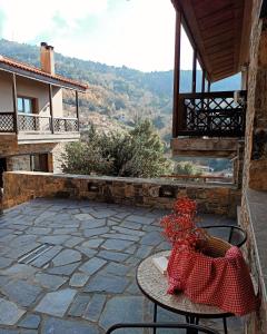 a table and chairs on a patio with a view at Guesthouse Vasiliki in Stení Dhírfios