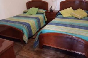 two beds sitting next to each other in a room at CASONA SARIEGO, APARTAMENTO in La Vega de Riosa