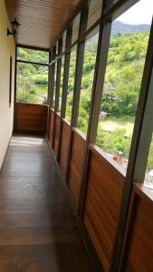 a hallway with windows and a door with a view at CASONA SARIEGO, APARTAMENTO in La Vega de Riosa