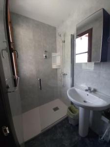 a bathroom with a sink and a shower and a toilet at CASONA SARIEGO, APARTAMENTO in La Vega de Riosa
