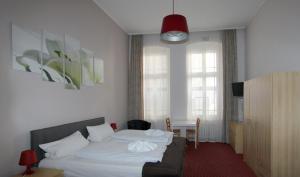 Postel nebo postele na pokoji v ubytování Hotel Elegia am Kurfürstendamm