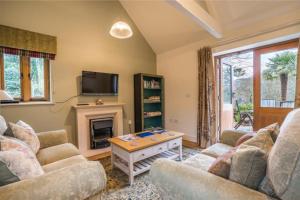 a living room with a couch and a fireplace at Maristow Cottages, overlook Tamar Valley Dartmoor in Plymouth