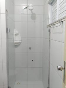 a bathroom with a shower with a glass door at Hotel Villa Real in Sobral