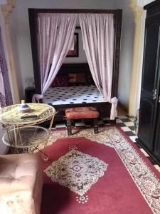 a living room with a couch and a table at Dar Sam - Pacha Room in Rabat