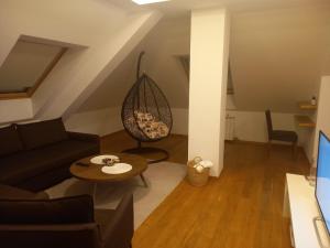 a living room with a couch and a table at Vila Borova Zlatibor Apartman 501 in Zlatibor