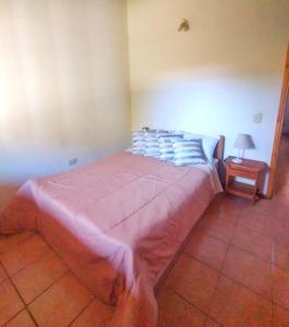 duże łóżko w pokoju ze stołem w obiekcie Alojamiento Casa en El Bolsón w mieście El Bolsón