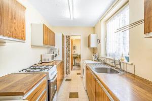 a kitchen with a sink and a stove at Tallis House, Sleeps 5, near City Centre, Free Parking, Long or Short Stays - by NMB Property in Manchester
