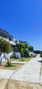 a house with a hose on the side of a street at CIELO Summer House Paros in Santa Marina