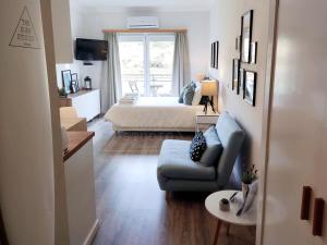 a living room with a couch and a bed at The Surf Studio - Ericeira in Ericeira