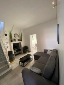 a living room with a couch and a fireplace at L'amiénoise proche zenith stade cathédrale in Amiens