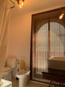 a bathroom with a tub and a toilet and a sink at El Racó de Xivert in Alcalá de Chivert