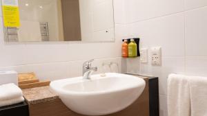 a bathroom with a white sink and a mirror at Holiday Inn Auckland Airport by IHG in Auckland
