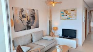 a living room with a couch and a tv at Hacienda Riquelme Golf Resort Groundfloor Apartment 176 in Sucina